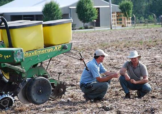 Joey Koptis (left) discusses soil health with Michael Mullek (right), a row crop farmer in Alabama