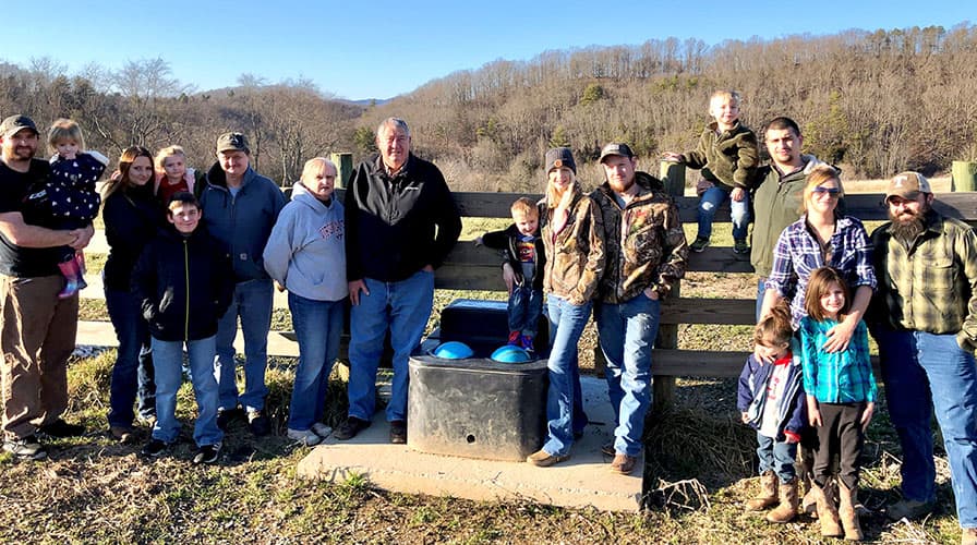 Bill Cooper, a cattle farmer from Wythe County, Virginia, with his large family on the farm.