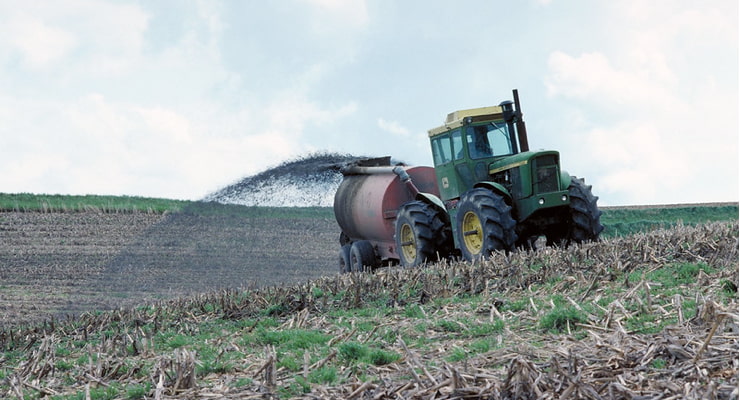 "Photo of a tractor applying fertilizer in a field"