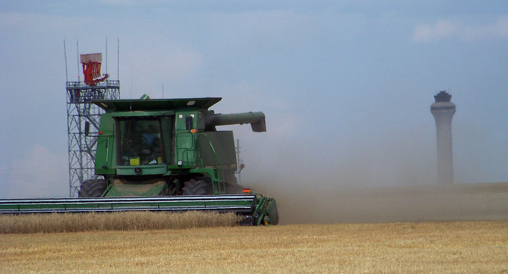 "Photo of a harvester crossing farm land"