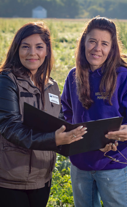 Service center employee helping a farmer