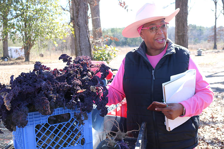 Dr. Cindy Ayers-Elliott with baskets of produce. 