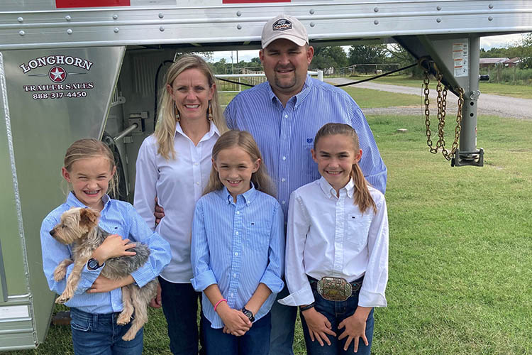 Montie and Julia Soules pose with their three daughters and dog.