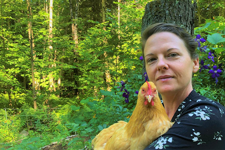 Carissa stands on her small acreage farm in Montgomery, Vermont.