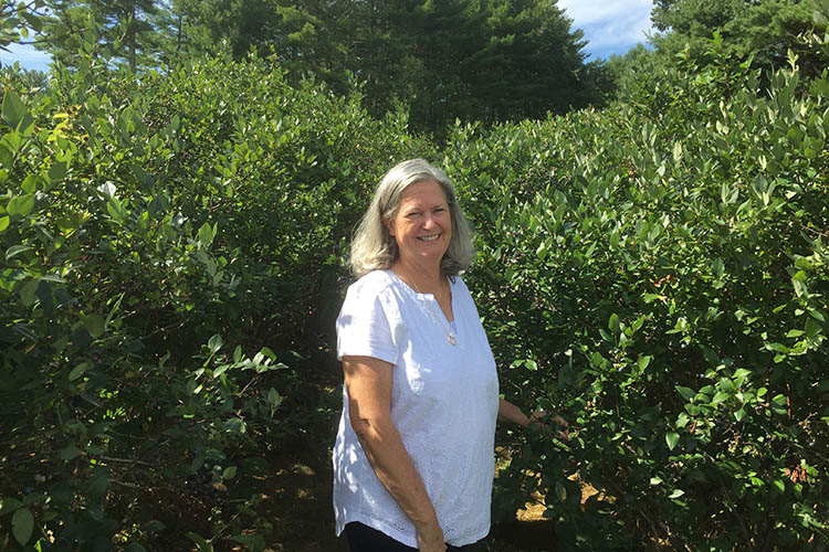 Ingrid Fratantuono, Agricultural Program Specialist for the USDA Farm Service Agency (FSA) State Office in Rhode Island, stands in a plant nursery field.