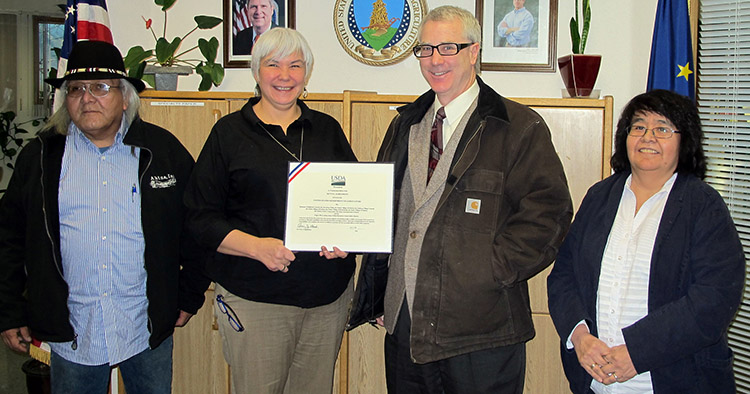 Copper River-Ahtna Inter-Tribal Resource Conservation District displaying their signed agreement with USDA in 2014.