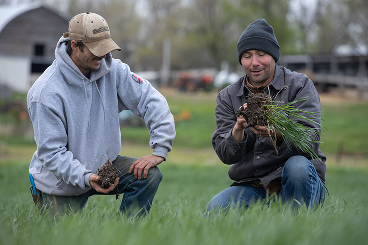 NRCS Soil Health Specialist Kent Vlieger (right) discusses soil structure with South Dakota Farmer Ryan Larson.