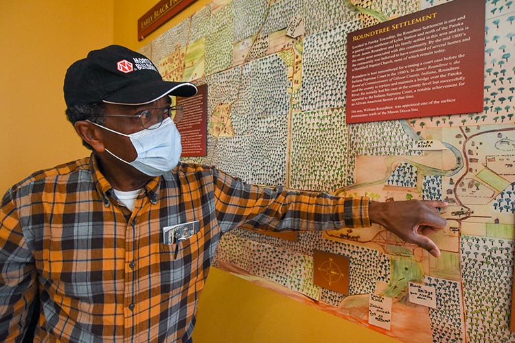 Stanley explains a map showing the area around Lyles Stations in the late 1800s and the locations of early Black colonies nearby