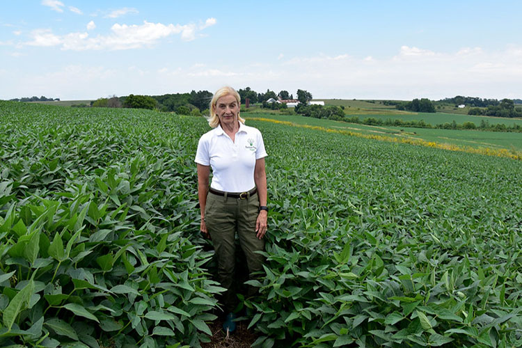 Maggie McQuown in a soybean field on her family’s Century Farm in Iowa. 