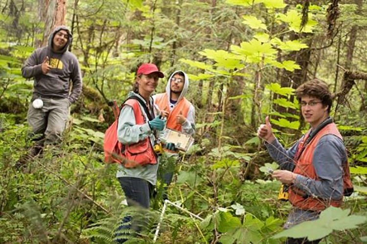 NRCS District Conservationist Samia Savell (center) with HNFP forest crew members prior to the pandemic. Photo by Ian Johnson, Sustainable Southeast Partnership.