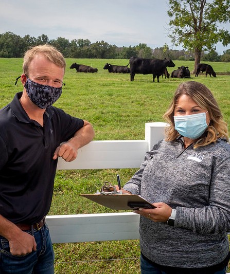 Service center employee helping a farmer