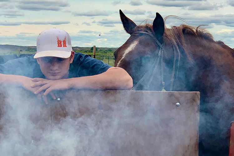 Nik Burke during branding on the ranch, by Tami Burke