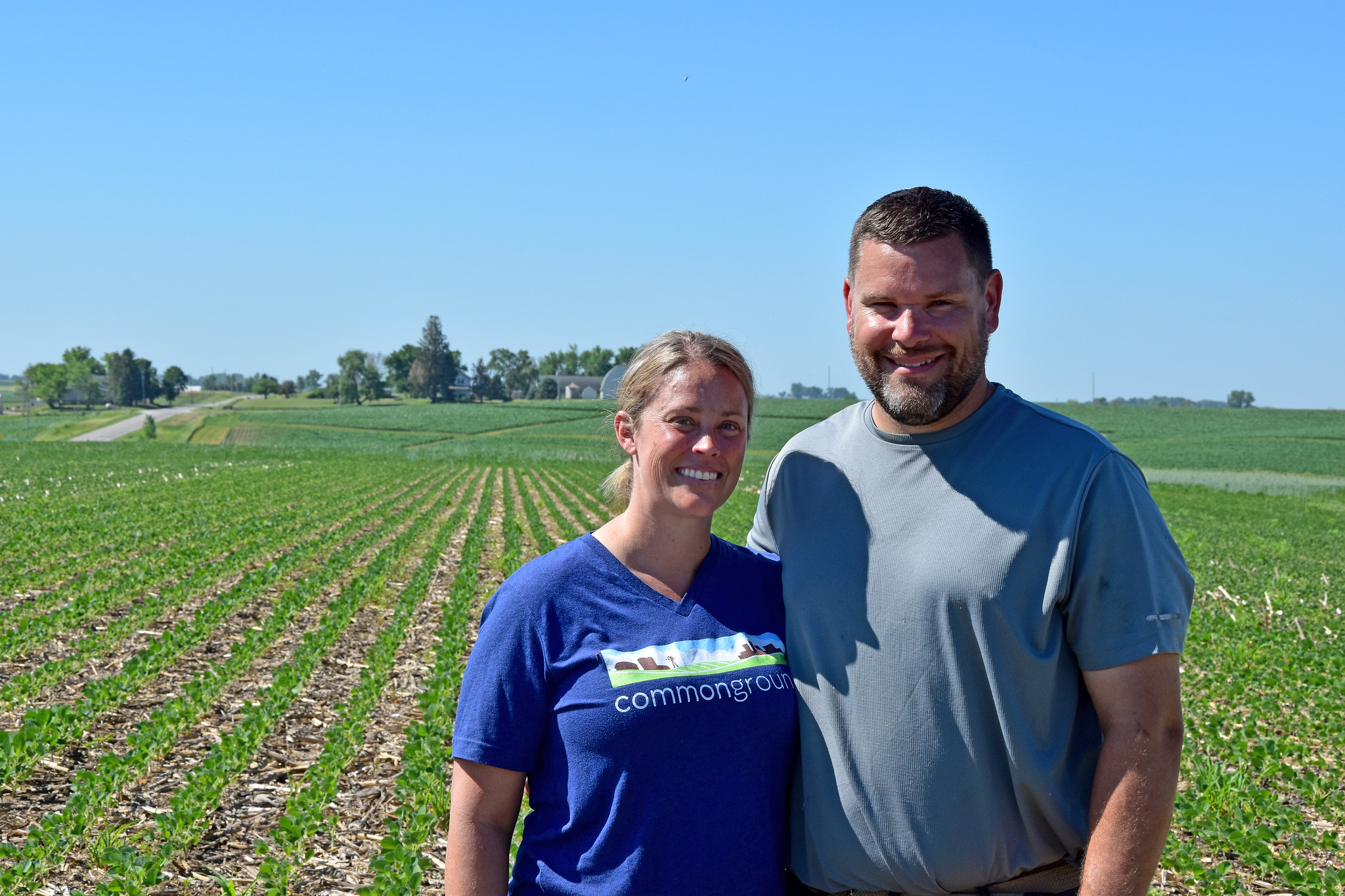 Two people stand in field