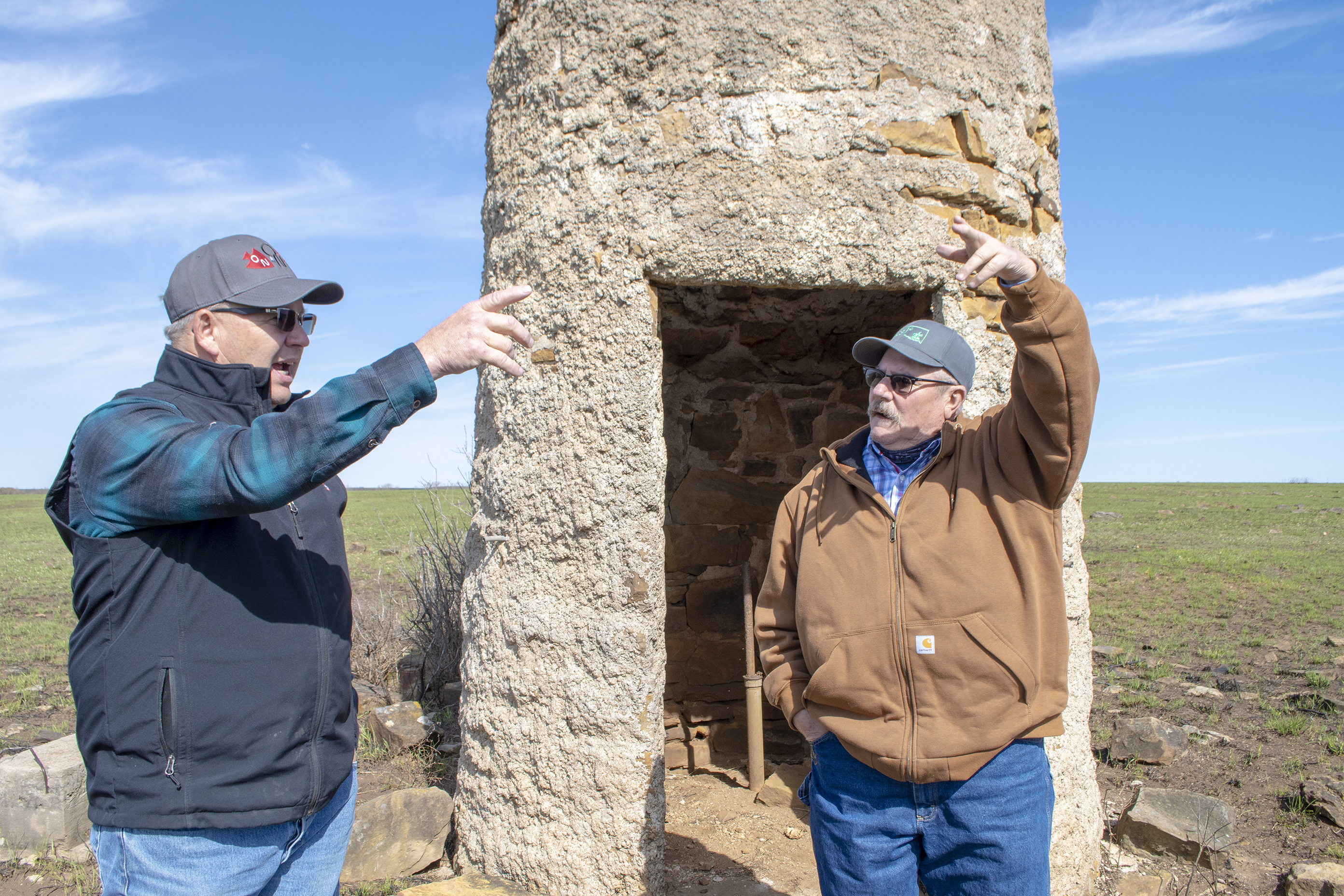 Two people talking to each other on open rangeland