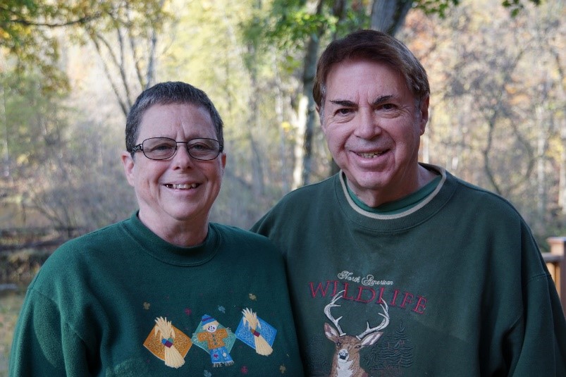 Two people smiling while facing camera