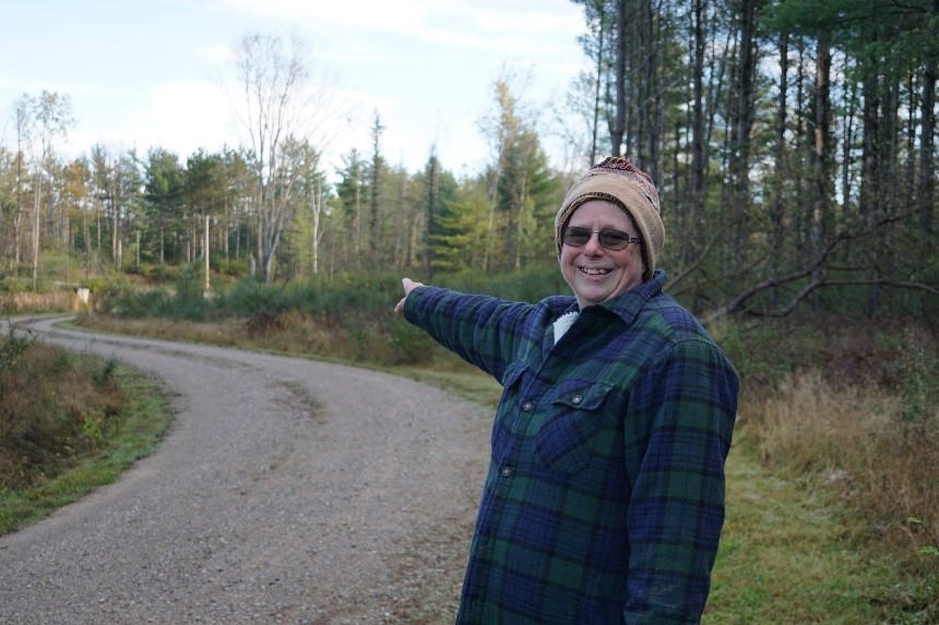 Person standing on road pointing