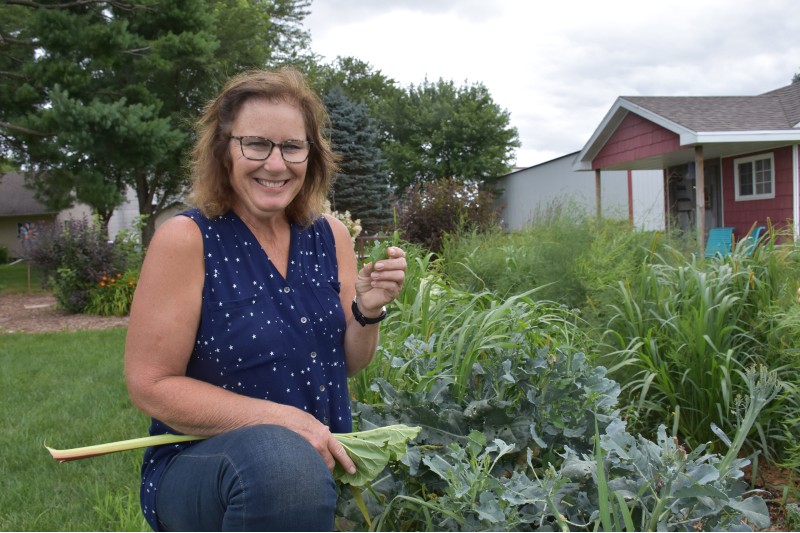 A woman excitedly holding a plant