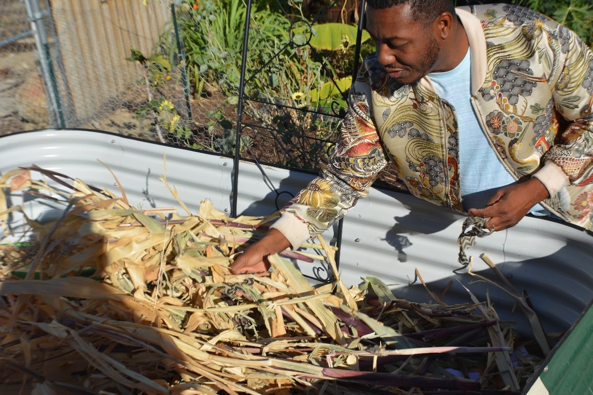 Person runs hand through composting bin