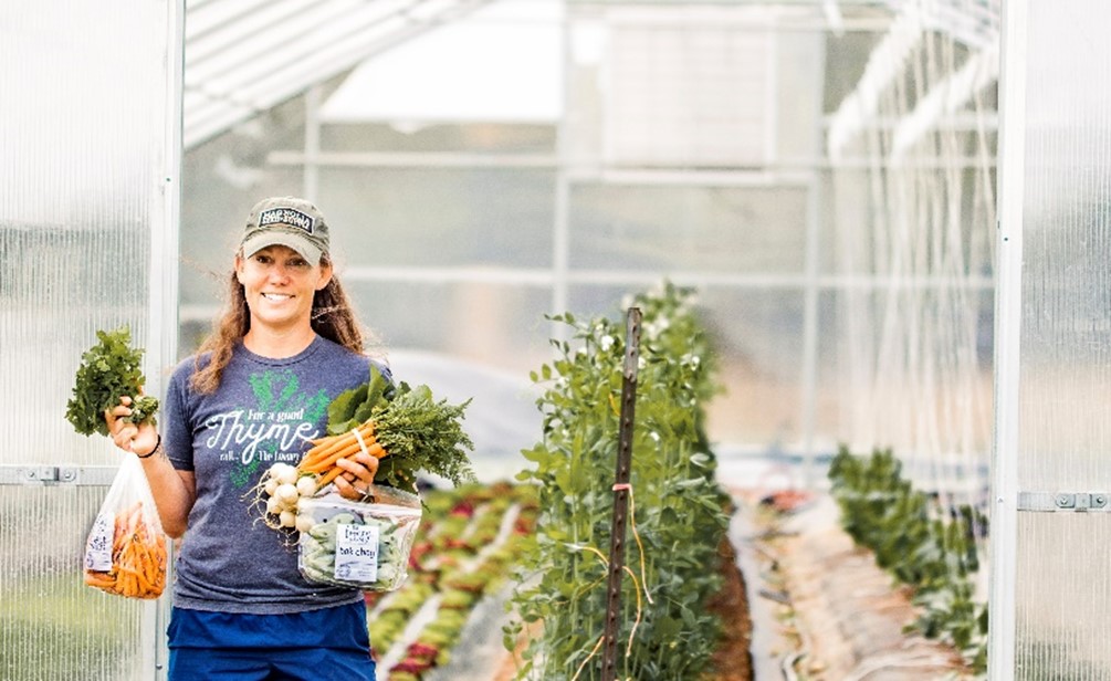 Person holding harvested vegetables