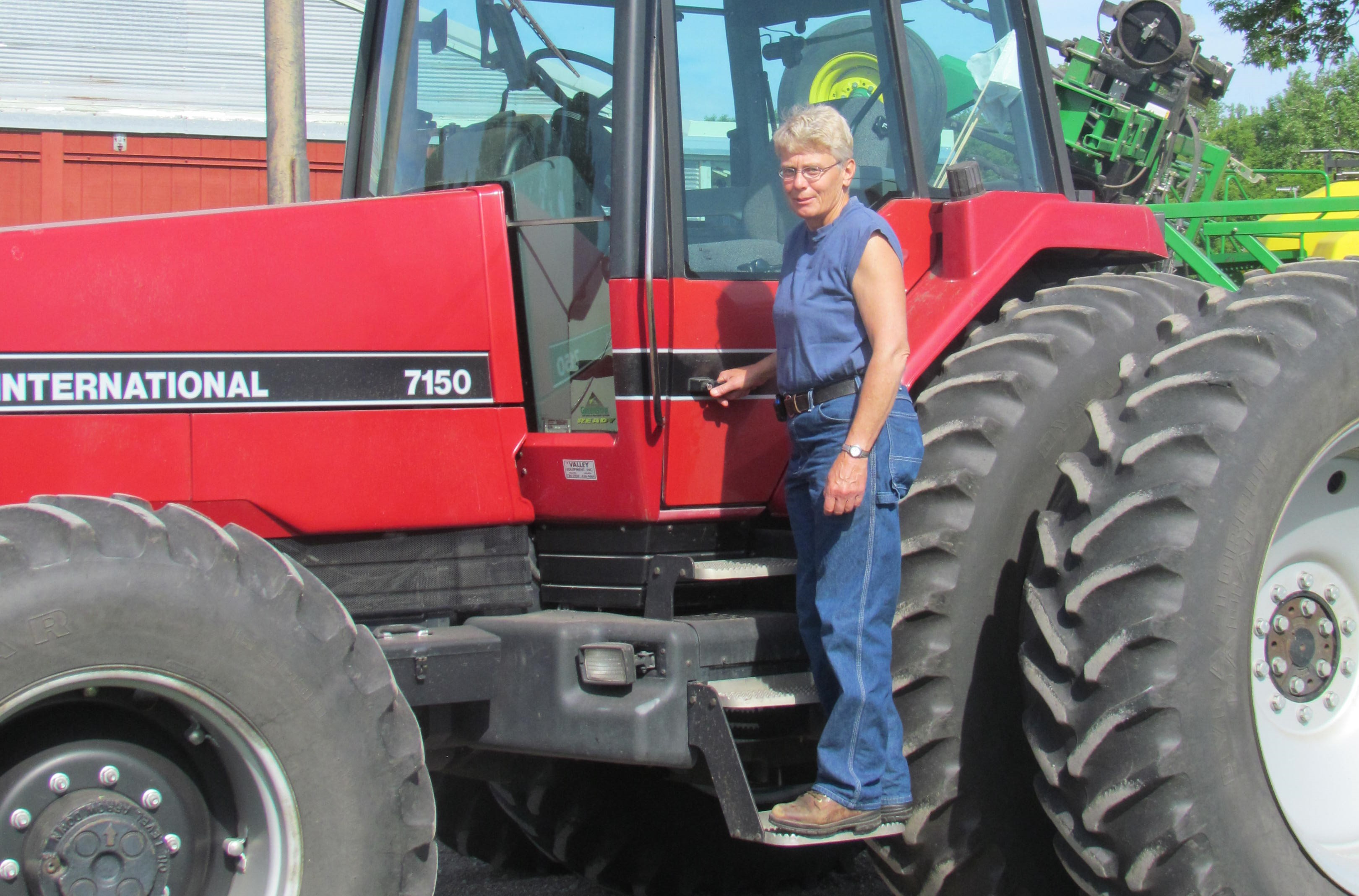 Person standing on tractor step