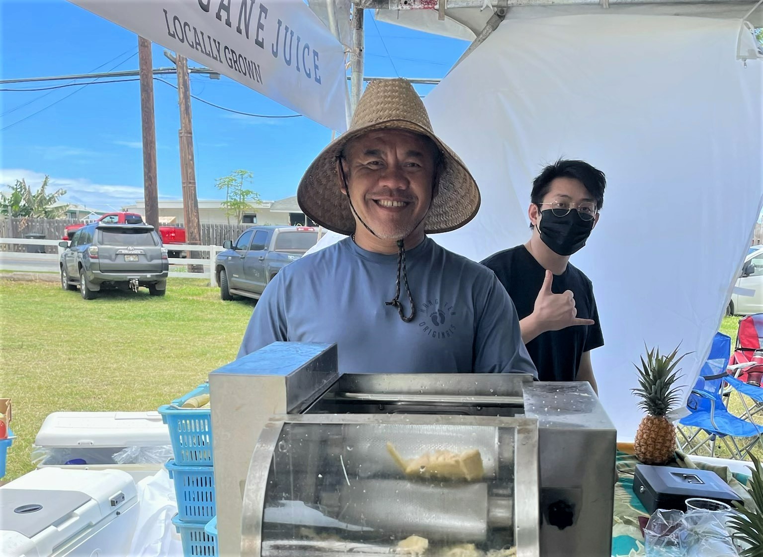 Person standing behind a sugar cane grinder