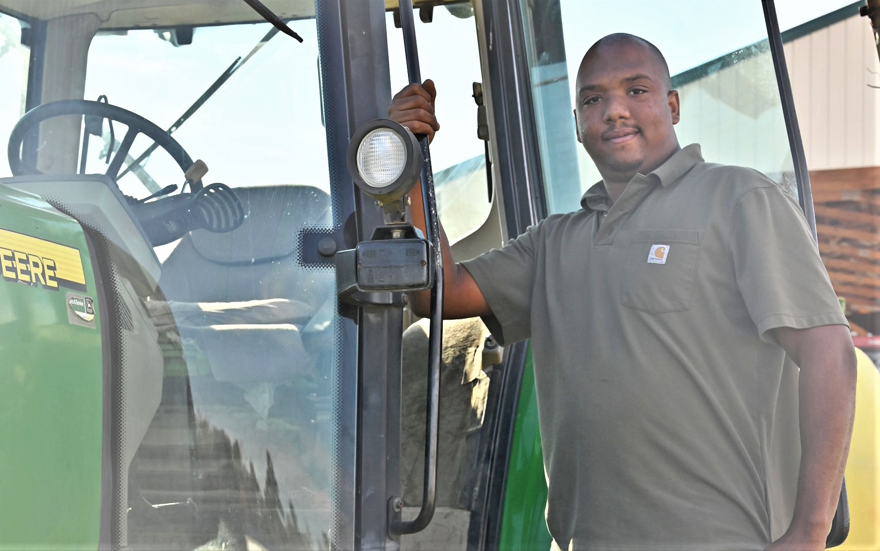 Person leaning on a green tractor