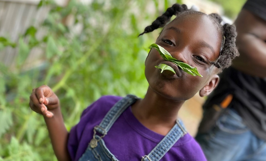 Person with mustache and beard made of leaves from garden