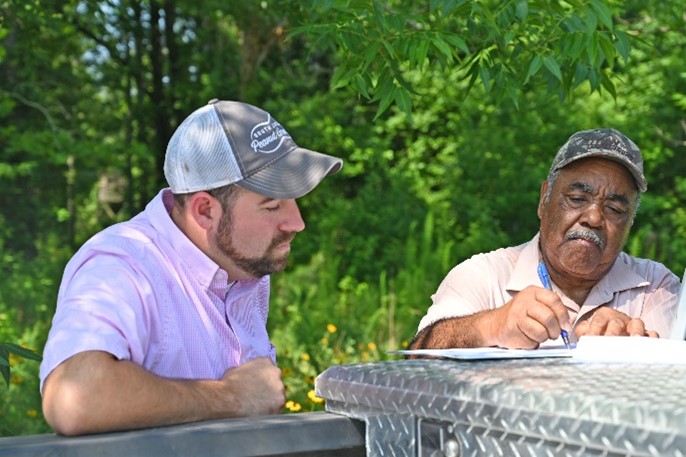 Two people talking while sitting at a picnic table
