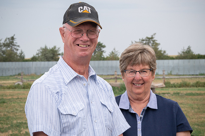 Two people standing with clear sky in background