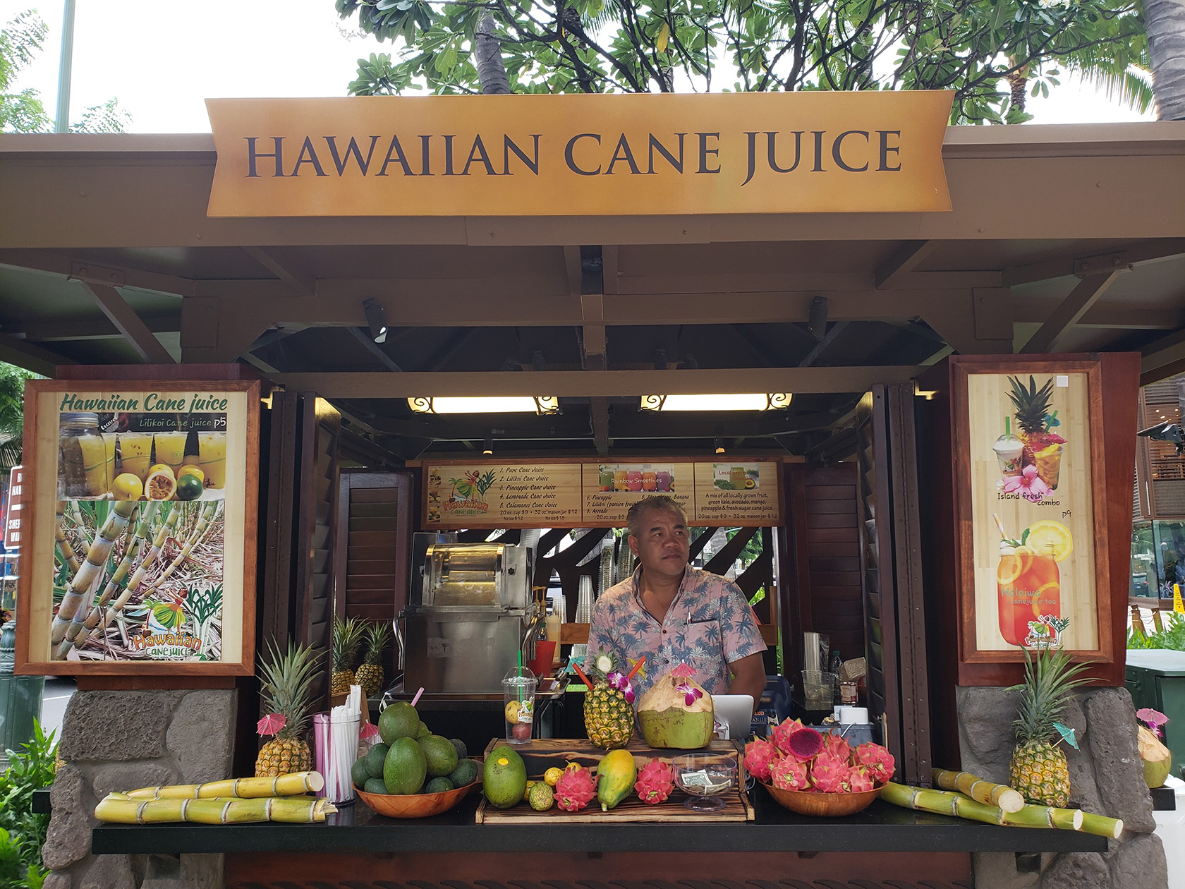 Person standing behind counter in a juice kiosk