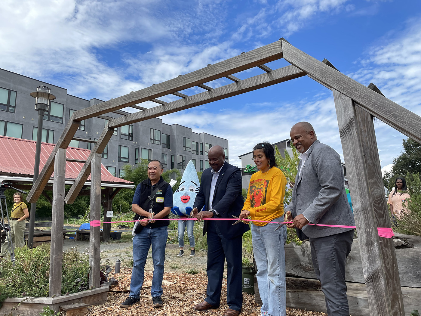 Four people cutting a ribbon