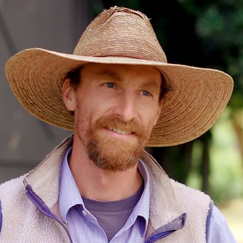 Person with cowboy hat on head