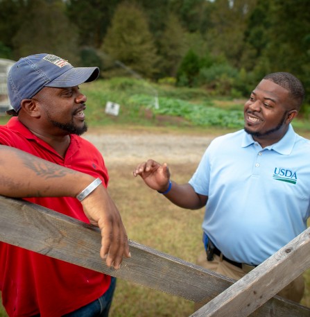 Service center employee helping a farmer