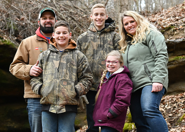 Five people standing in brush