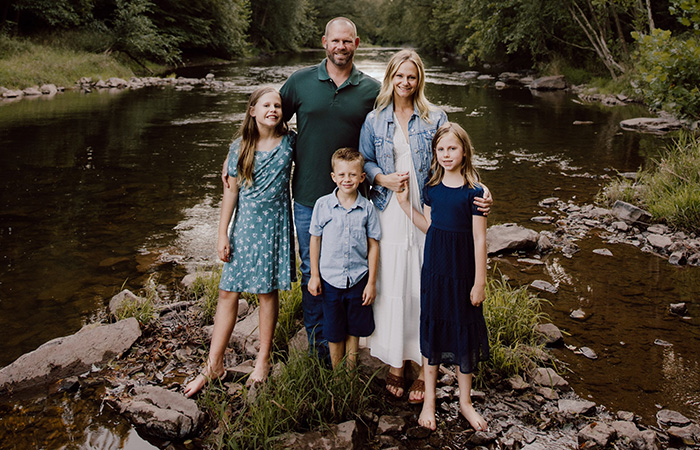 Five people standing in creek