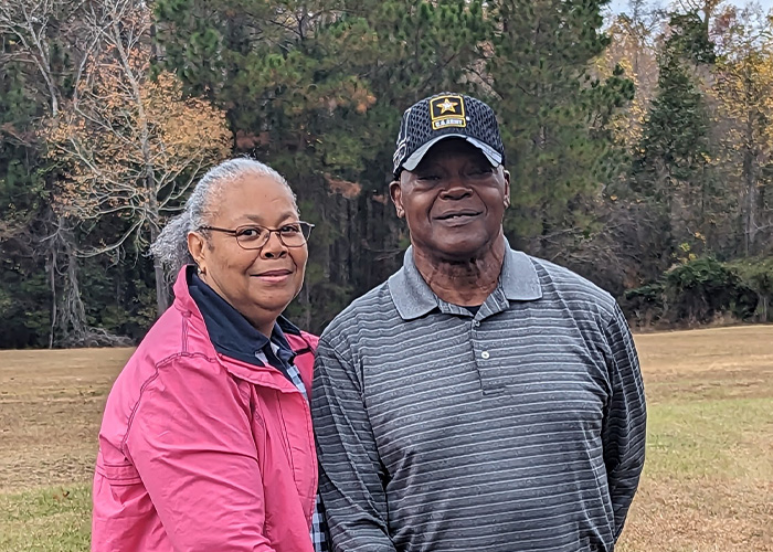 Two people standing on grass