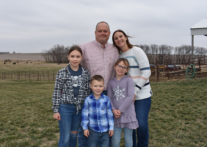 Five people standing in field