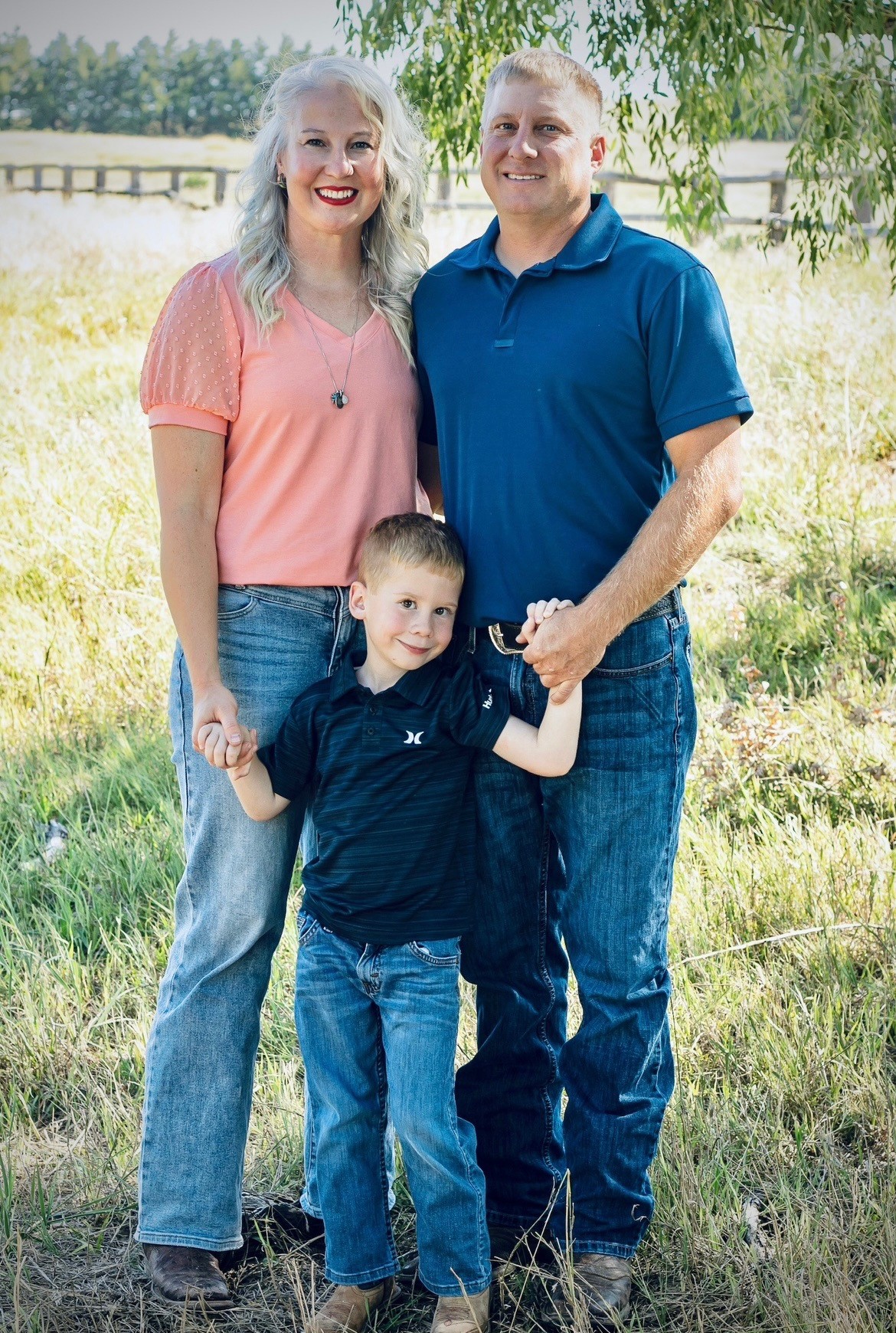 Three people standing in a field
