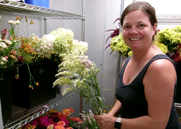 Person standing in a room with flowers