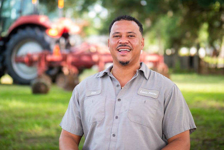 Person standing in front of a tractor