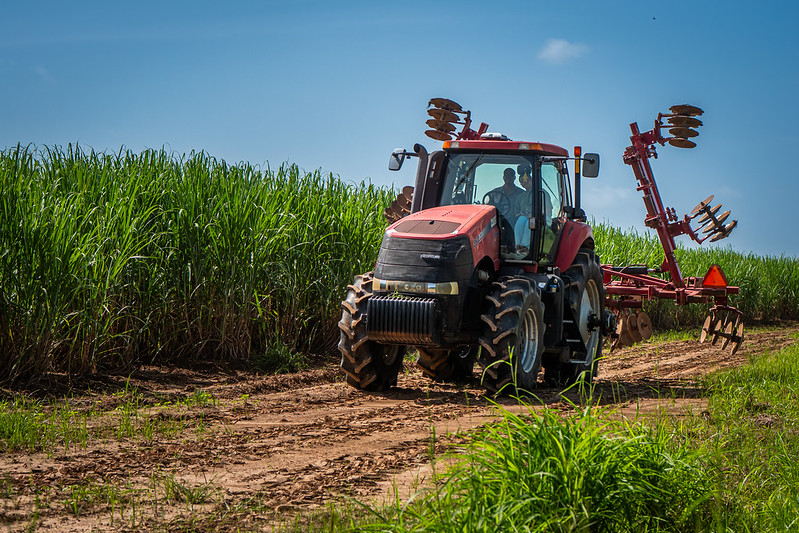 Person driving a tractor on a dirt road