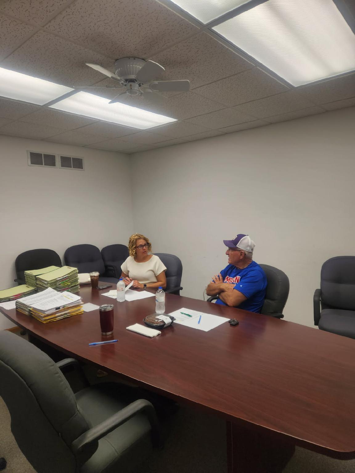 Two people sitting in a conference room