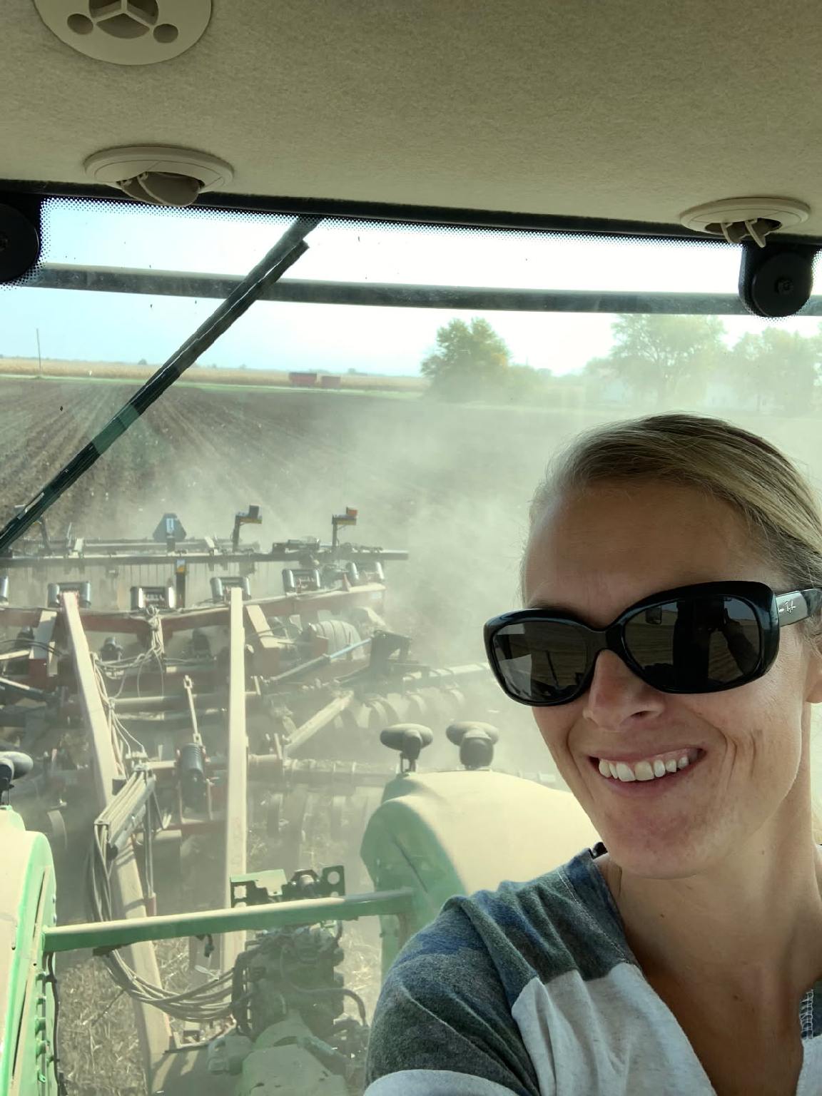Person smiling while sitting in a tractor