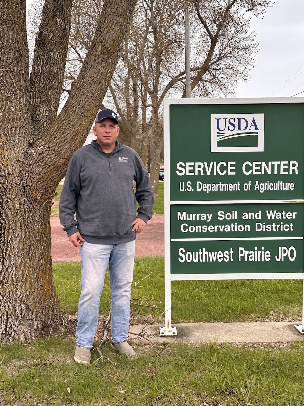 Person standing next to a sign