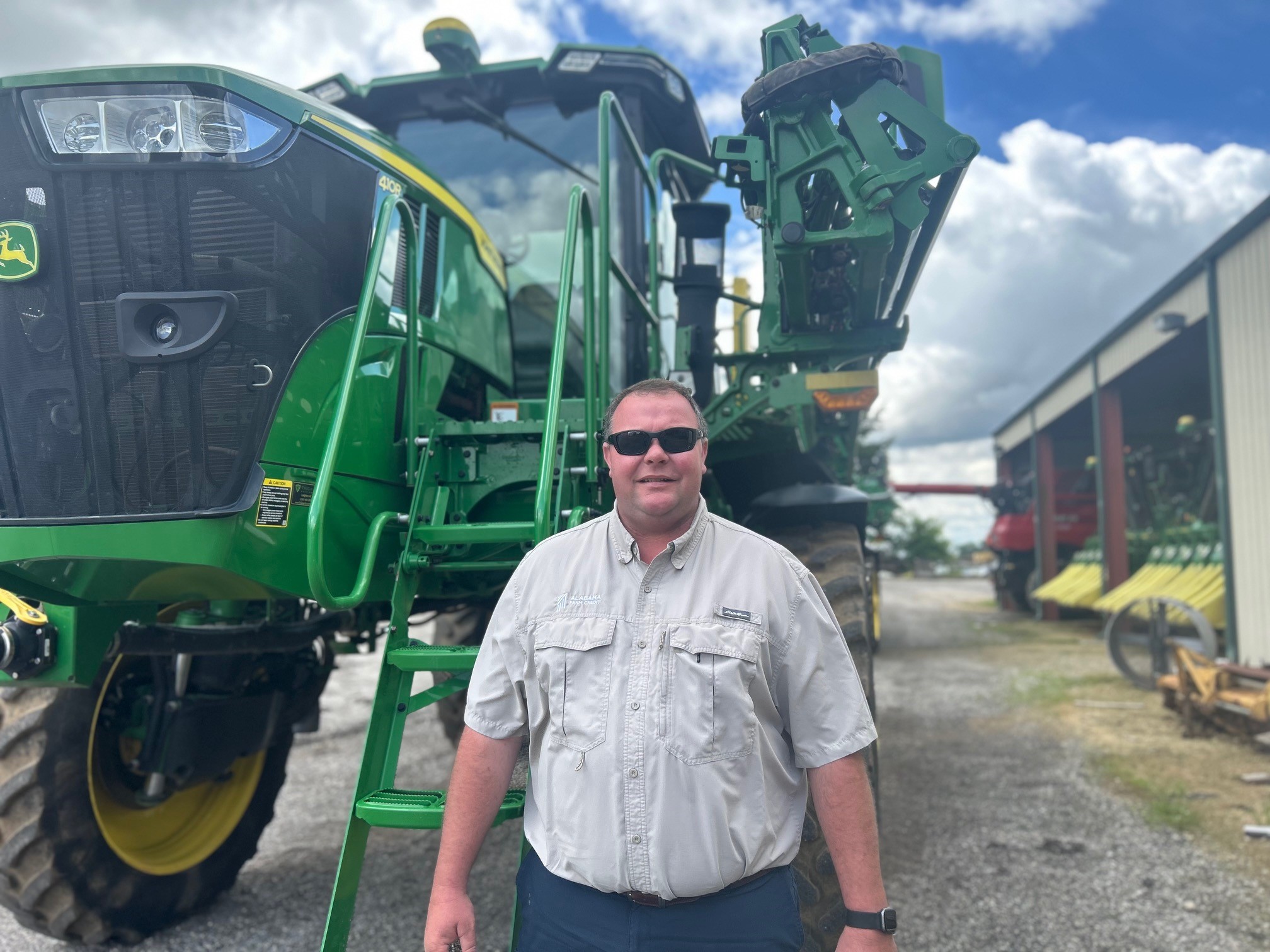 Person standing in front of a tractor