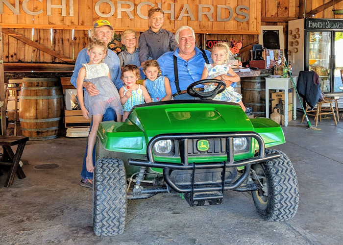 Eight people sitting on a four wheeler