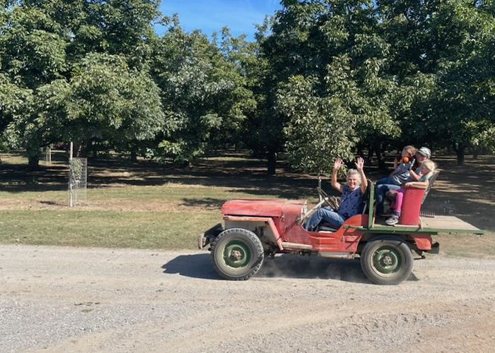 Eight people riding in a four wheeler