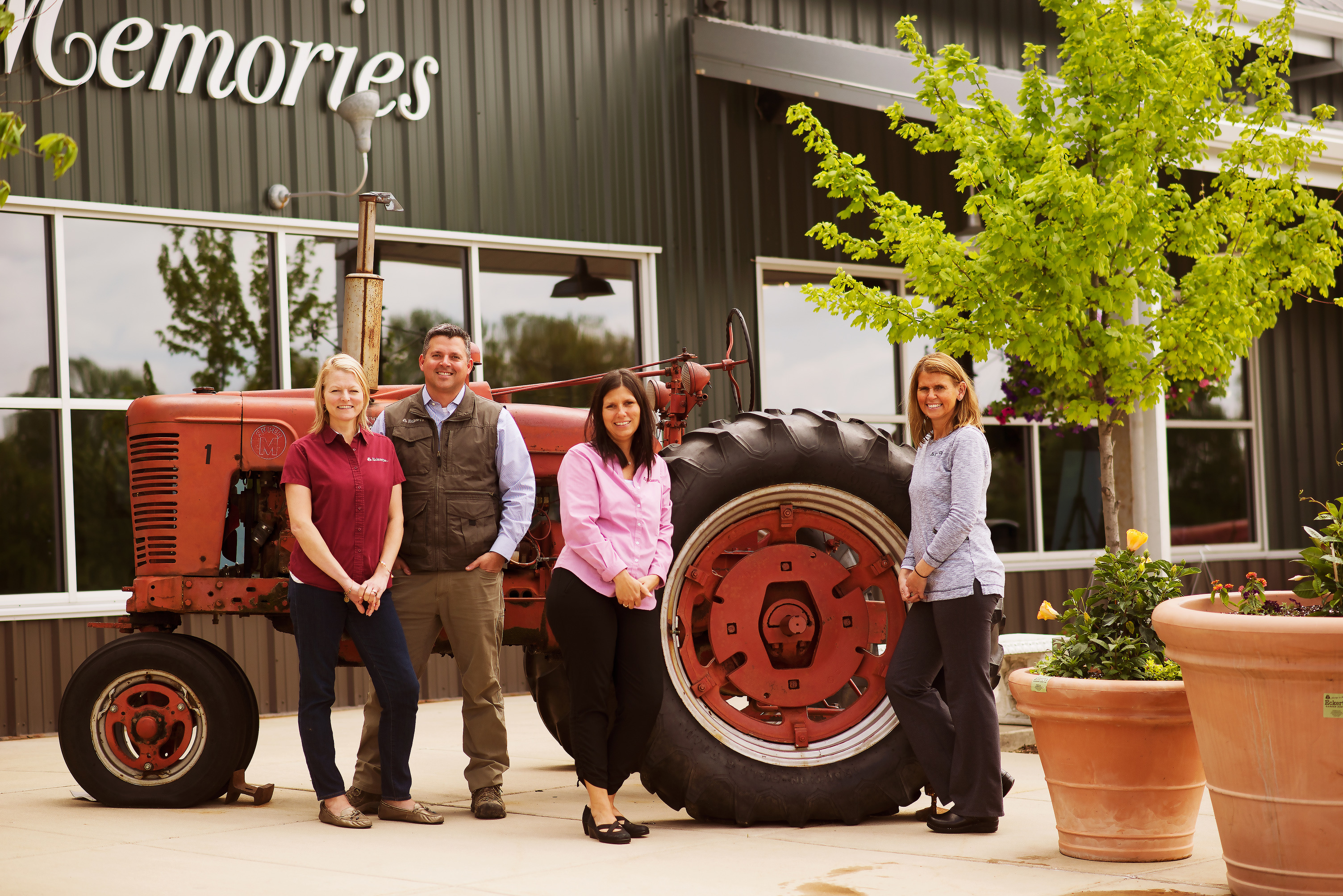 Farmer Chris Eckert with his wife and sisters by a tractor in front of the family store.