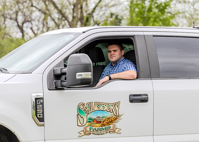 Person sitting in the driver's side of a truck