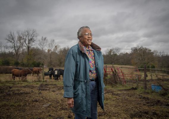Pat Crenshaw standing on her land